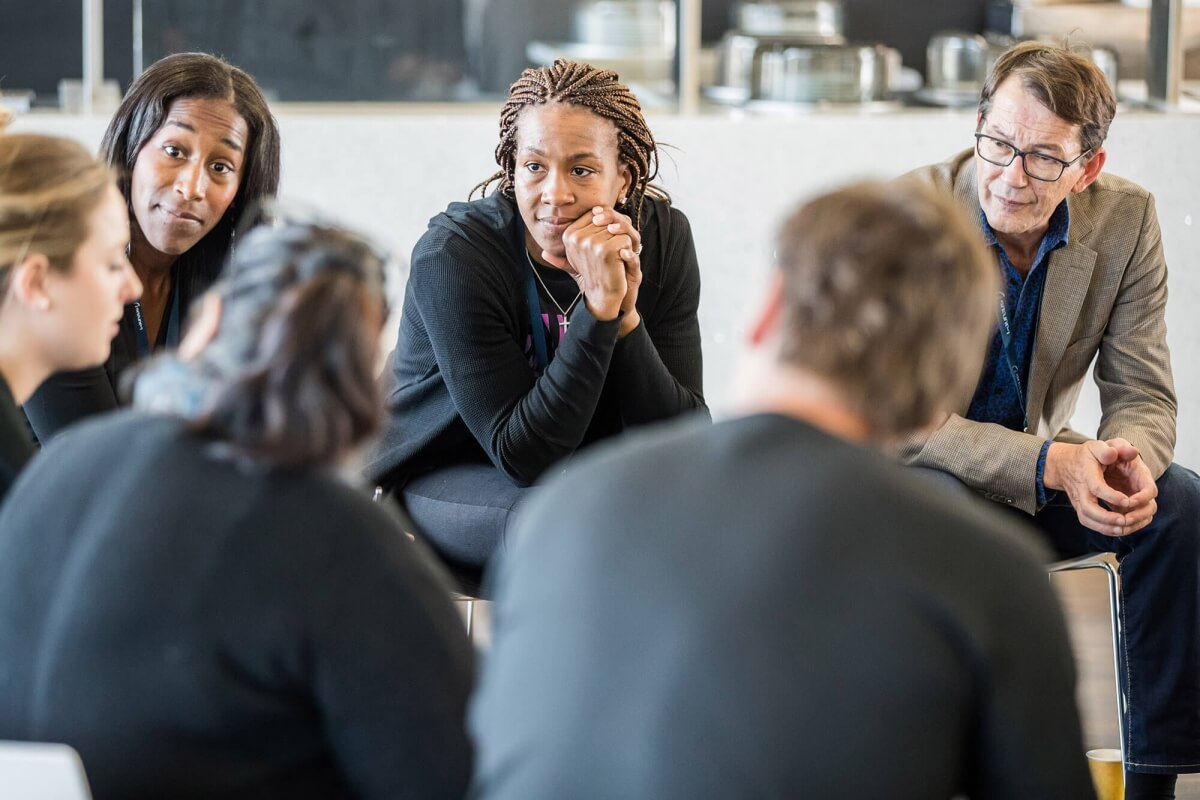 A group sat in a circle having a discussion during a session with Laureus 