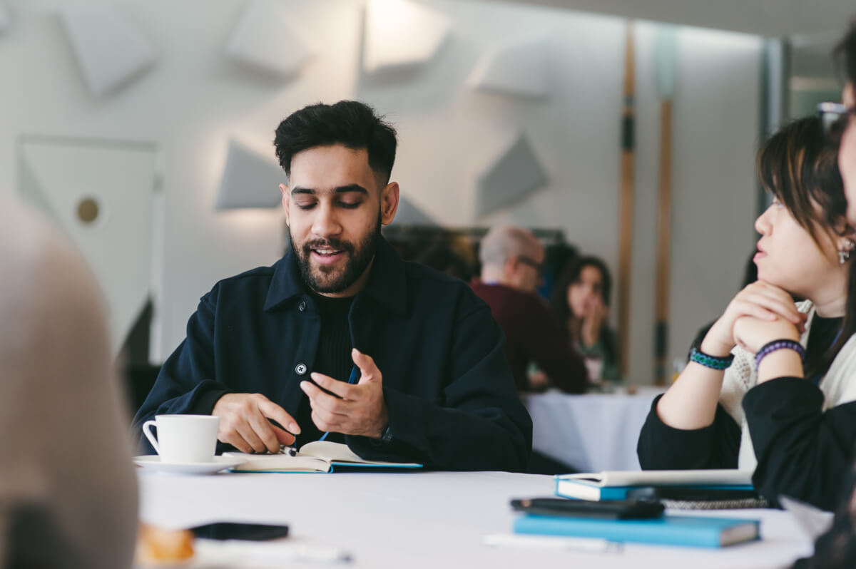 A team sat at a table having a discussion during one of our Wavelength sessions