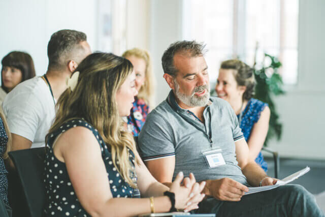 Two team members having a conversation during an iEQ9 Enneagram session with Immediate Media
