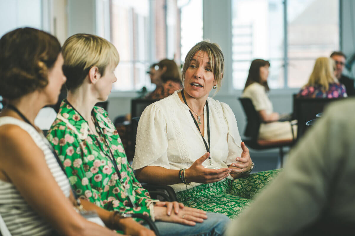 CoCreator, Lucy Dennis, speaking to two Immediate Media employees during an iEQ9 Enneagram session