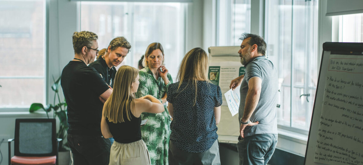 A group stood in a circle having a discussion during a leadership session with Immediate Media