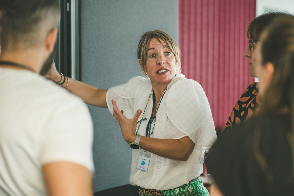 Lucy Dennis speaking to a group during a leadership and team development session with Immediate