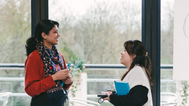 Two people having a discussion during a leadership session